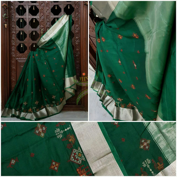 Bottle green Kota cotton saree with kasuti embroidery. Saree is woven with tissue border and pallu.