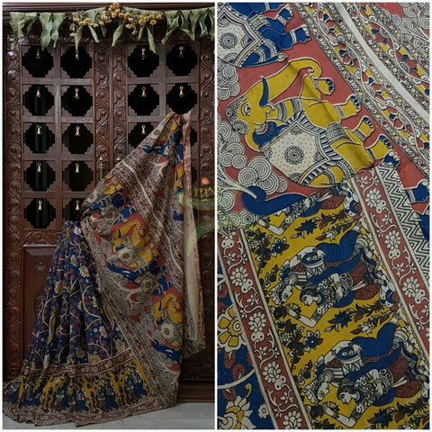 Blue mul cotton kalamkari with intricate floral motif on body of the saree, human figure motif on the border and elephant and floral motif on the pallu.
