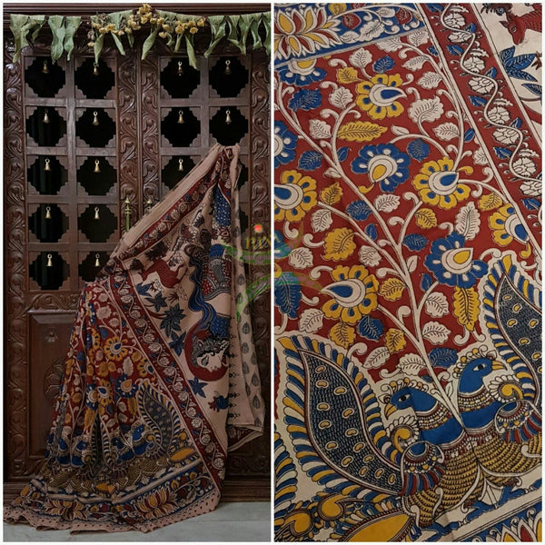 Red mul cotton kalamkari with intricate floral and peacock motif on body of the saree, floral motif on the border and human figure and peacock motif on the pallu.