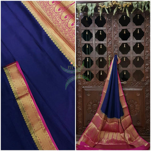 Navy blue with pink Art silk crepe with woven zari border and pallu.