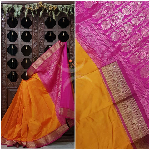 Mustard with pink handloom small Ghatti border pure south silk saree woven with floral brocade pattern on pallu, border and has floral booties all over.