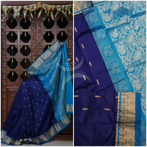 Royal blue with blue small Ghatti border pure south silk saree woven with floral brocade pattern on pallu and border. Saree has paisley drop booties all over.