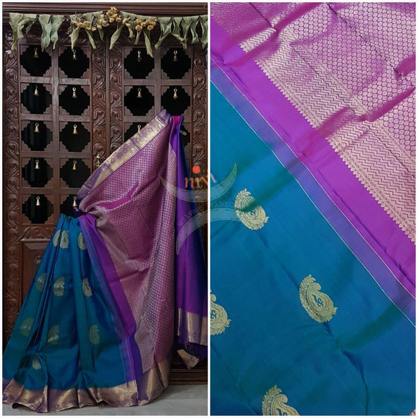 Teal with pink handloom pure kanjivaram  silk saree woven with paisley booties all over the saree and  brocade pattern on pallu and border.