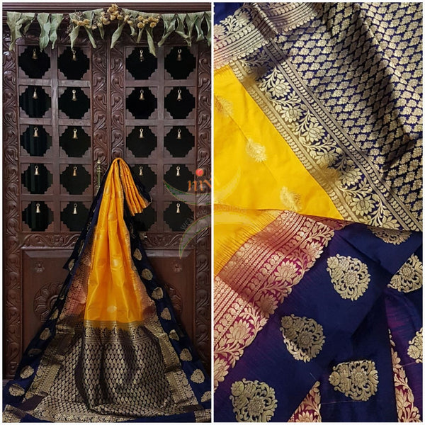 Mustard with double shaded royal blue and pink border pure south silk saree woven with floral brocade pattern on pallu and border. Saree has paisley drop booties all over.