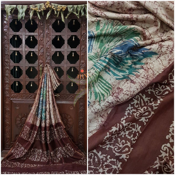 Off white with brown Handloom pure tussar silk with batik print woven with fine zari lines.