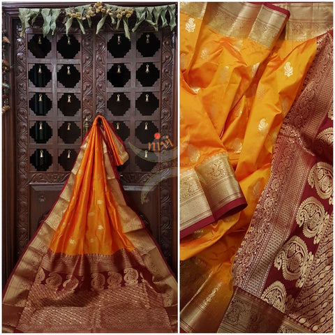Mustard with maroon pure south silk saree woven with paisley and floral brocade pattern on pallu, border and has paisley and floral booties all over.