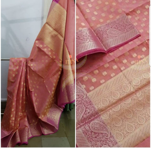 Peach shot pink silk cotton benaras brocade with paisley and floral woven motifs. The saree comes with gold finish blouse piece to match pallu.